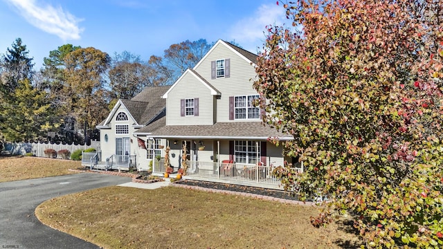 view of front of home with a front yard and covered porch