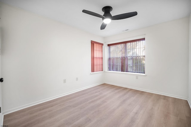 spare room with light hardwood / wood-style flooring and ceiling fan