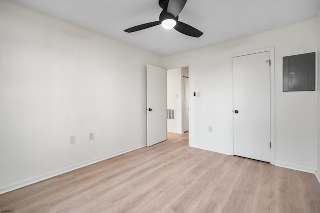 unfurnished bedroom with electric panel, ceiling fan, and light hardwood / wood-style floors