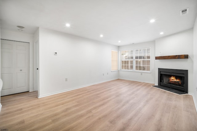 unfurnished living room with light hardwood / wood-style floors