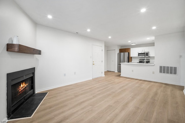 unfurnished living room featuring light hardwood / wood-style floors