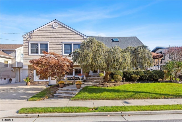 view of front of home with a front yard and a garage