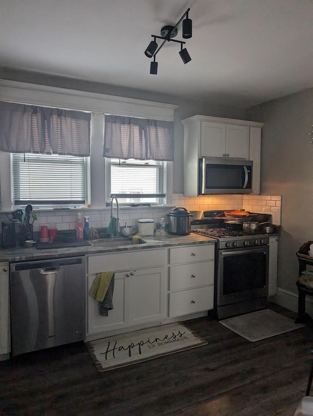 kitchen featuring sink, white cabinets, stainless steel appliances, and dark hardwood / wood-style floors