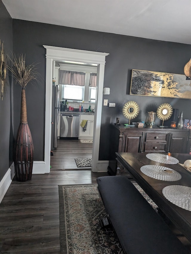 dining area with dark hardwood / wood-style floors