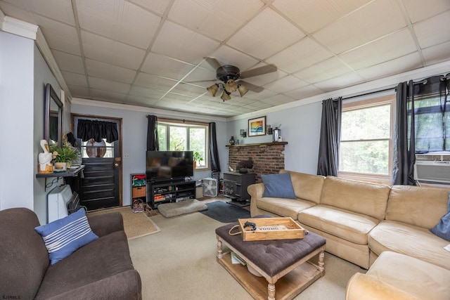 carpeted living room featuring cooling unit, a paneled ceiling, ornamental molding, and ceiling fan