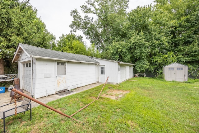 view of yard with a garage and a shed