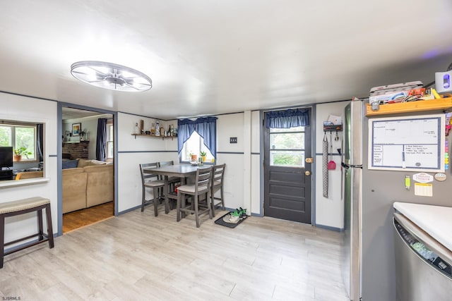 kitchen featuring stainless steel appliances and light hardwood / wood-style flooring