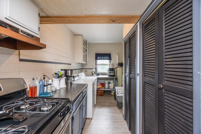 kitchen featuring white cabinetry, backsplash, gas range, and light wood-type flooring