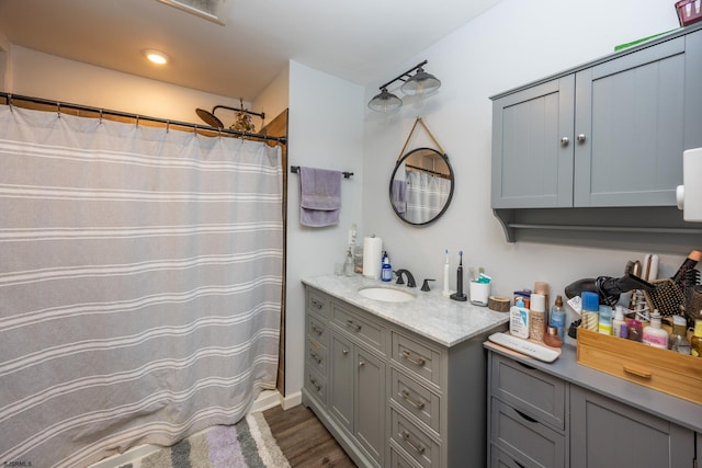 bathroom with vanity, wood-type flooring, and walk in shower