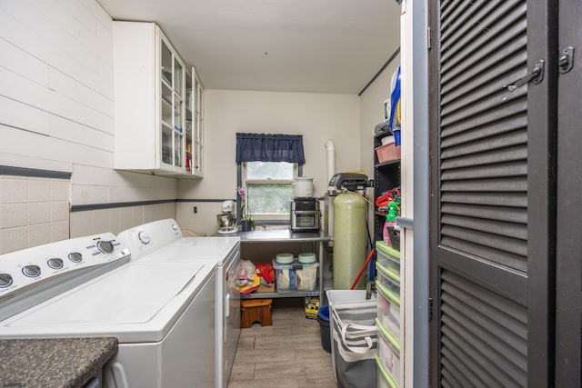 laundry room featuring washer and dryer and light wood-type flooring