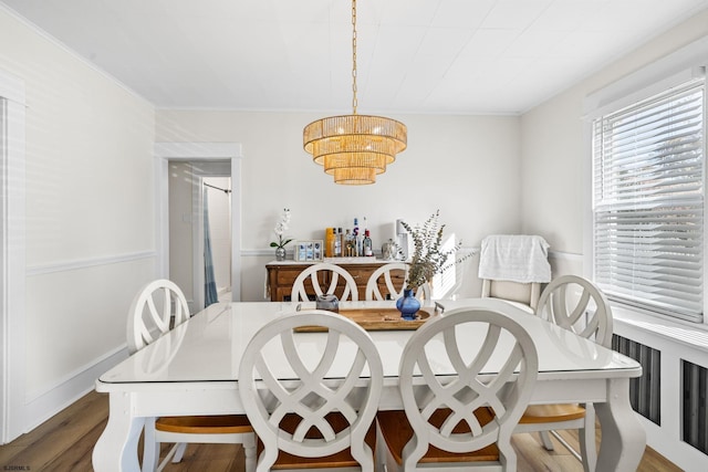 dining room with dark hardwood / wood-style flooring and an inviting chandelier