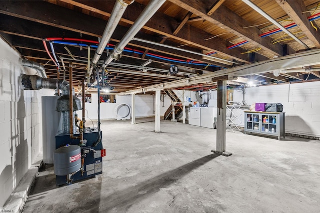 basement with gas water heater and independent washer and dryer