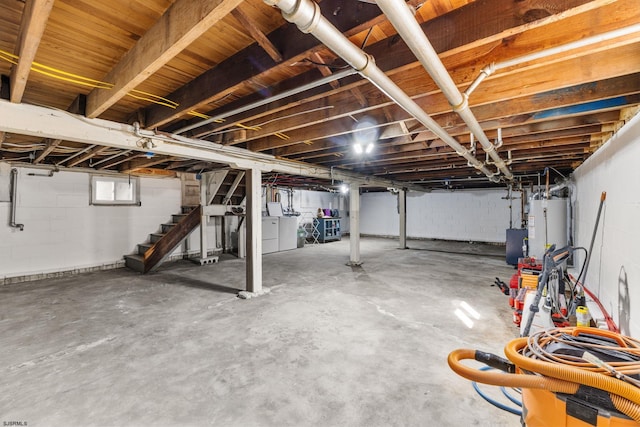 basement featuring washer and dryer and water heater