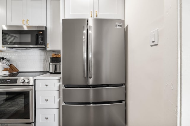 kitchen featuring decorative backsplash, white cabinetry, and stainless steel appliances