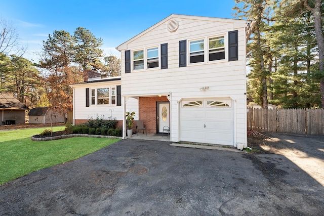 split level home with a front yard and a garage