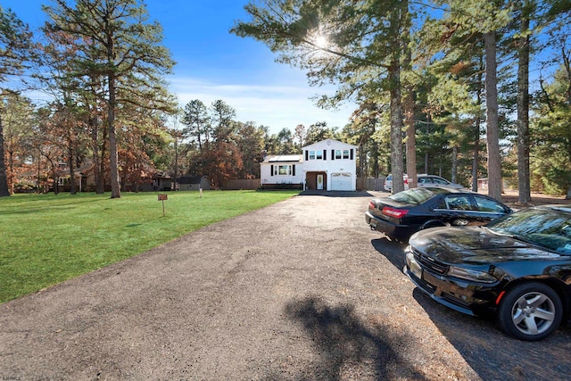 view of front of property with a front yard and a garage