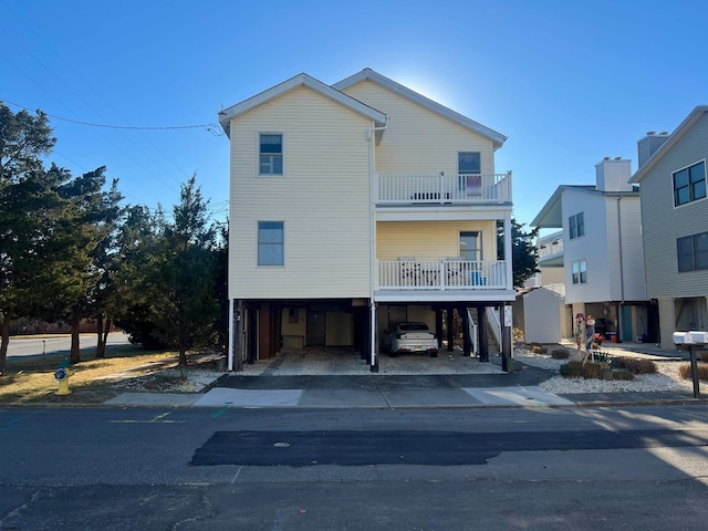 view of front of house with a balcony and a carport