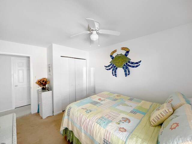 carpeted bedroom featuring a closet and ceiling fan