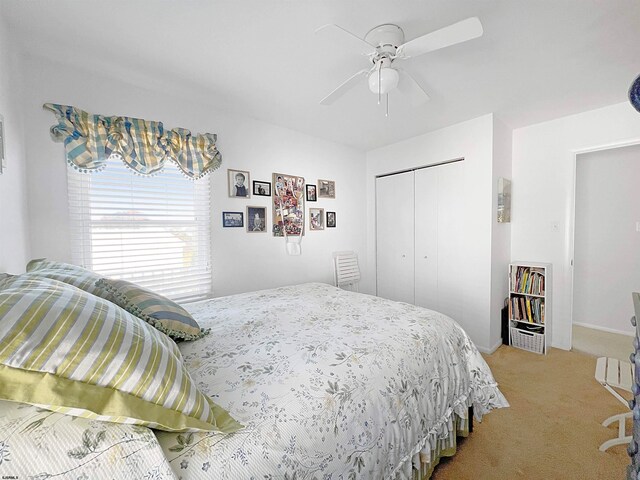 carpeted bedroom with a closet and ceiling fan