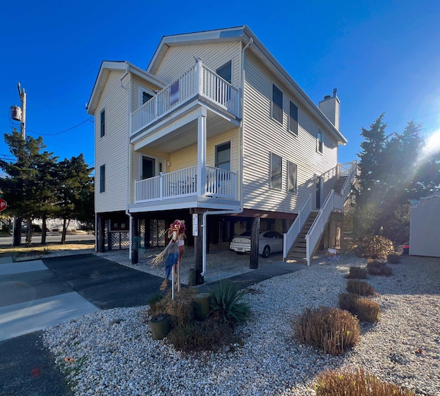 exterior space with a balcony and a carport