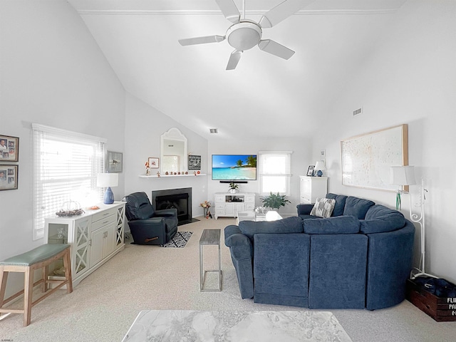 living room with light carpet, ceiling fan, a healthy amount of sunlight, and high vaulted ceiling