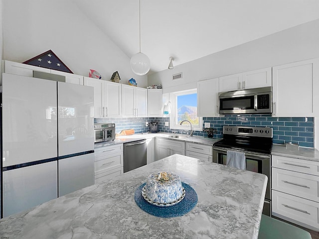 kitchen featuring light stone counters, white cabinetry, sink, and appliances with stainless steel finishes