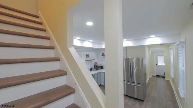 staircase with hardwood / wood-style floors