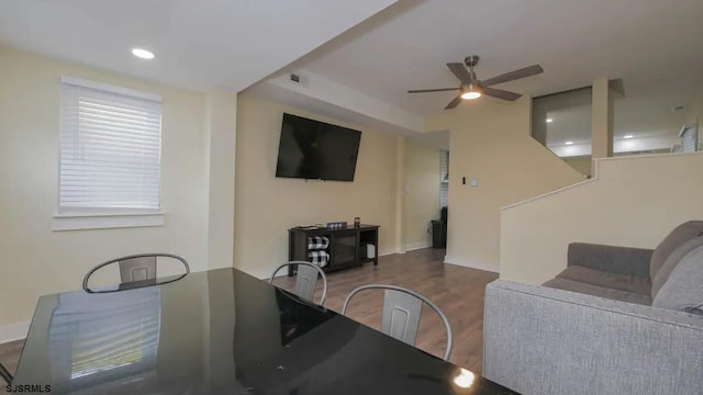 living room featuring dark hardwood / wood-style floors and ceiling fan