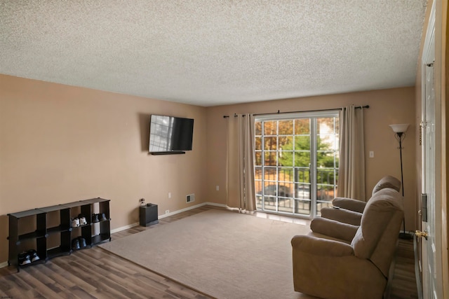 sitting room featuring a textured ceiling and hardwood / wood-style flooring