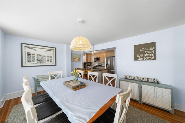 dining area with dark hardwood / wood-style floors