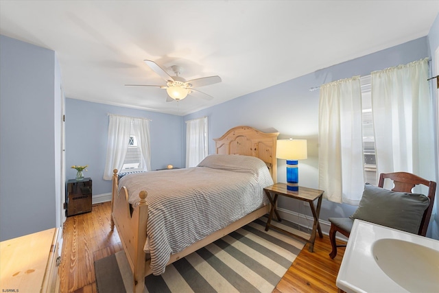 bedroom with light wood-type flooring and ceiling fan