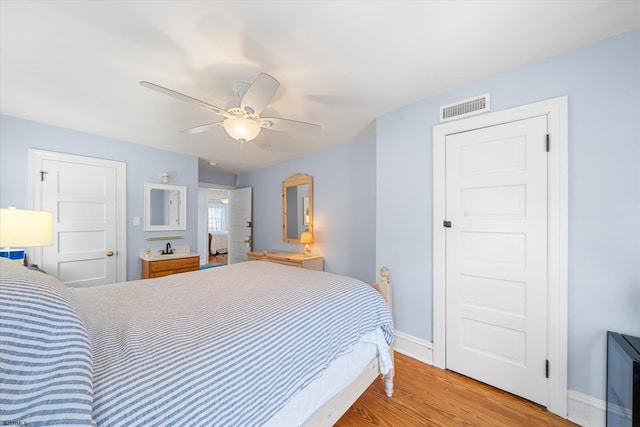 bedroom with light hardwood / wood-style flooring and ceiling fan