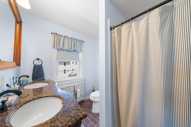 bathroom featuring a shower with shower curtain, vanity, toilet, and radiator