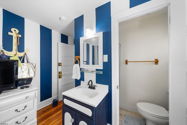 bathroom featuring vanity, toilet, and wood-type flooring