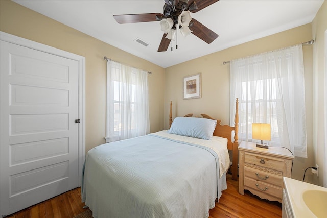 bedroom with hardwood / wood-style floors and ceiling fan