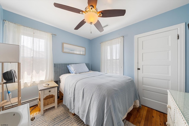 bedroom with ceiling fan and dark hardwood / wood-style floors