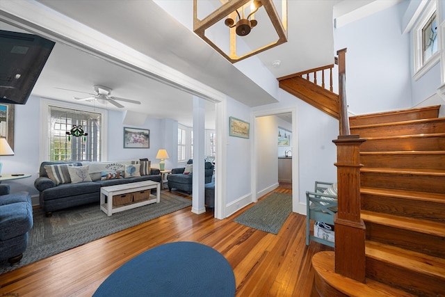 living room featuring hardwood / wood-style floors and ceiling fan