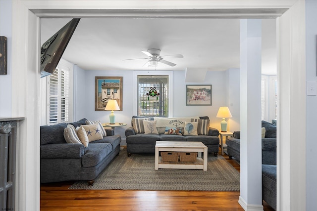 living room featuring ceiling fan, plenty of natural light, and hardwood / wood-style flooring