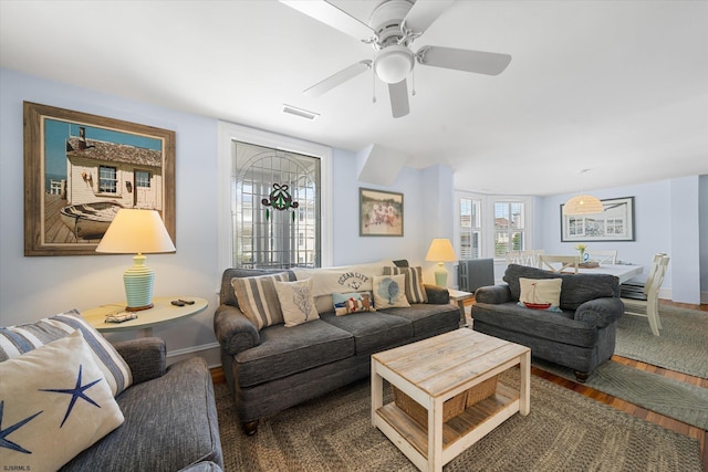 living room with dark hardwood / wood-style floors and ceiling fan