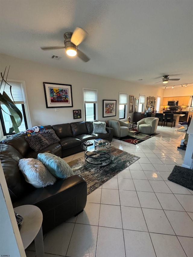 living room with ceiling fan and light tile patterned floors