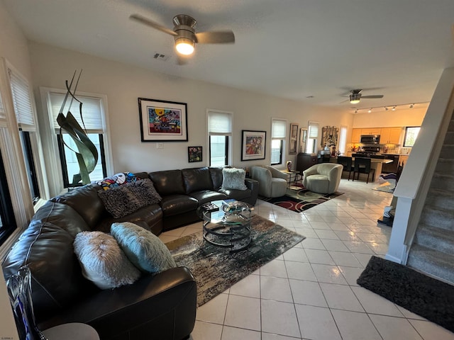 living room with light tile patterned floors and ceiling fan