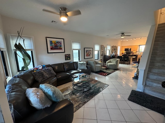 living room with ceiling fan and light tile patterned floors