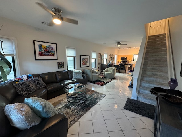 living room featuring ceiling fan and light tile patterned flooring