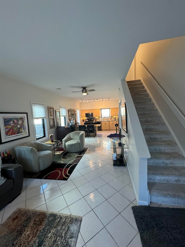 living room with ceiling fan and light tile patterned floors