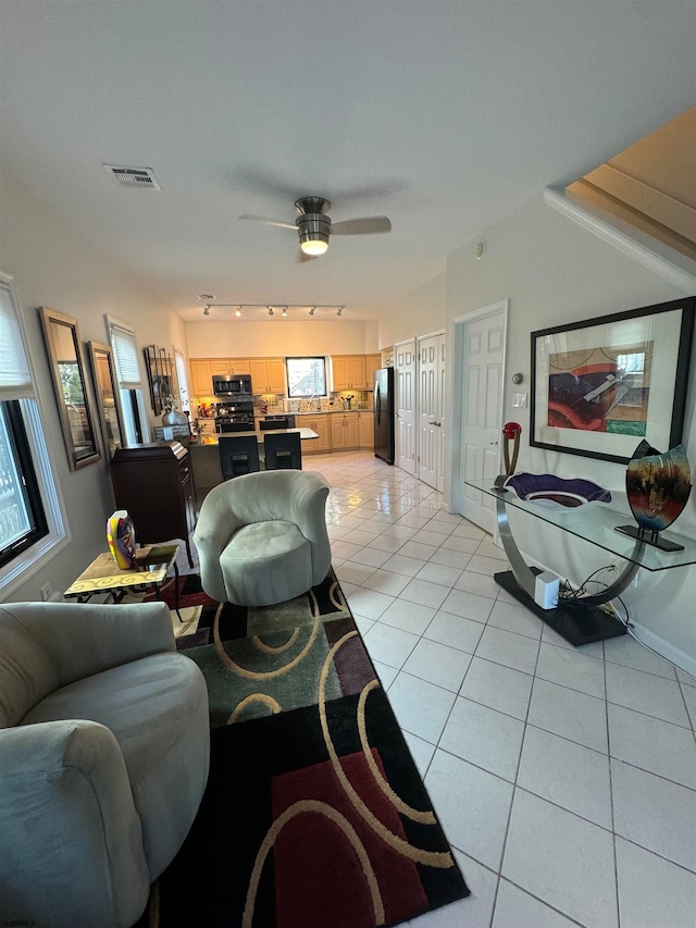 tiled living room featuring ceiling fan