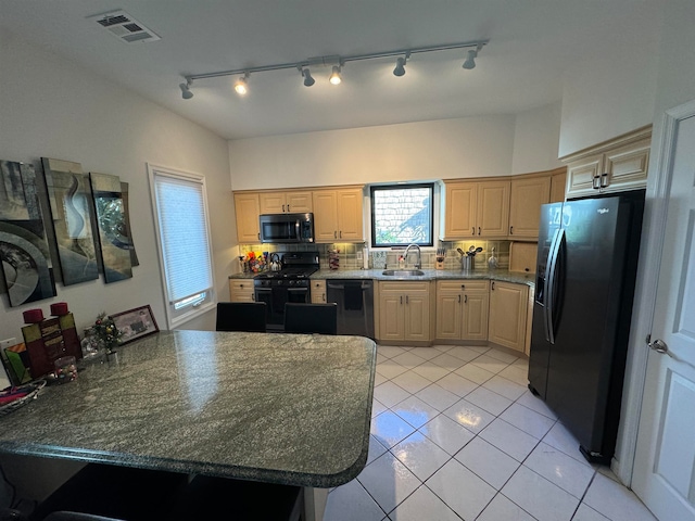 kitchen with backsplash, black appliances, sink, light tile patterned floors, and light brown cabinetry