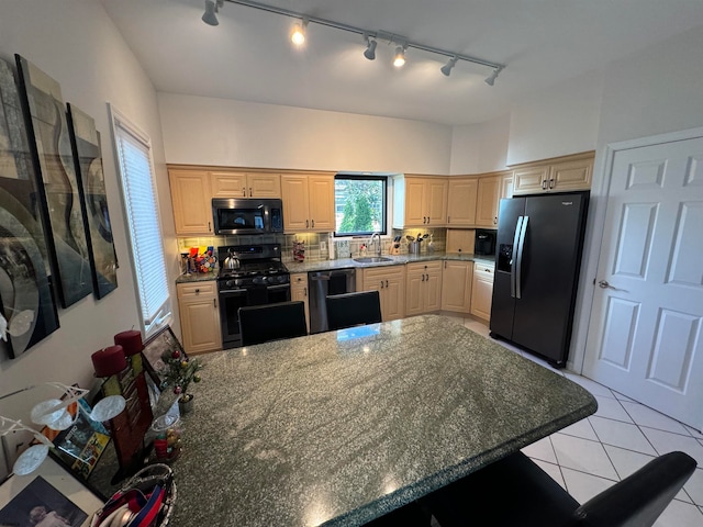 kitchen featuring decorative backsplash, light brown cabinets, sink, and black appliances