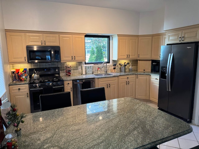 kitchen with tasteful backsplash, light stone counters, sink, and stainless steel appliances