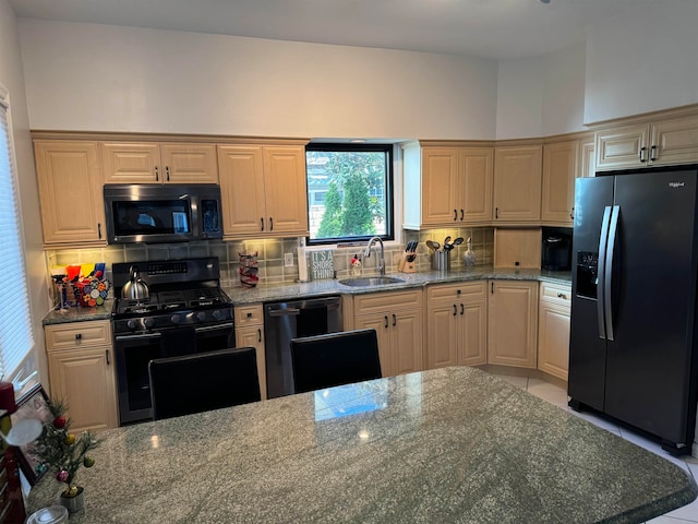 kitchen featuring backsplash, sink, light stone countertops, light tile patterned floors, and stainless steel appliances