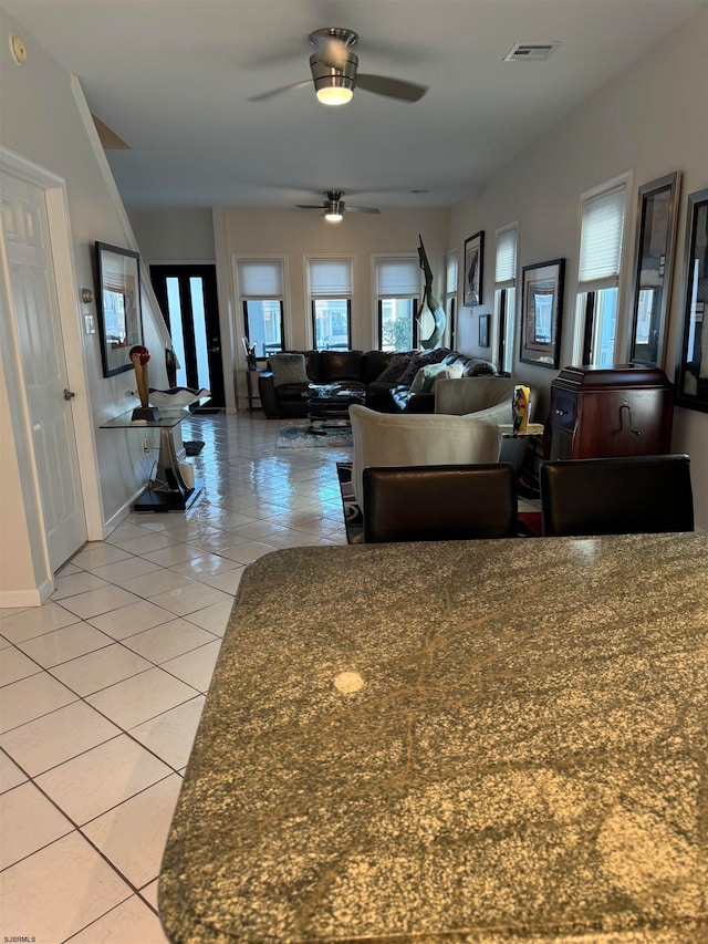 tiled living room featuring ceiling fan